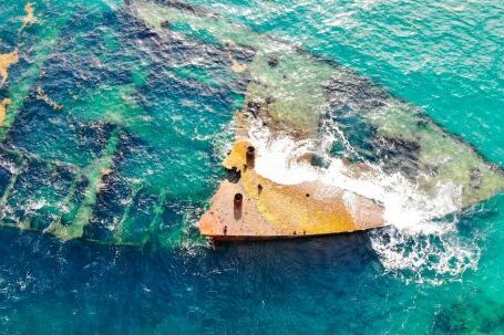 Sunken Ship - Aerial View of Shipwreck in the Middle of Ocean